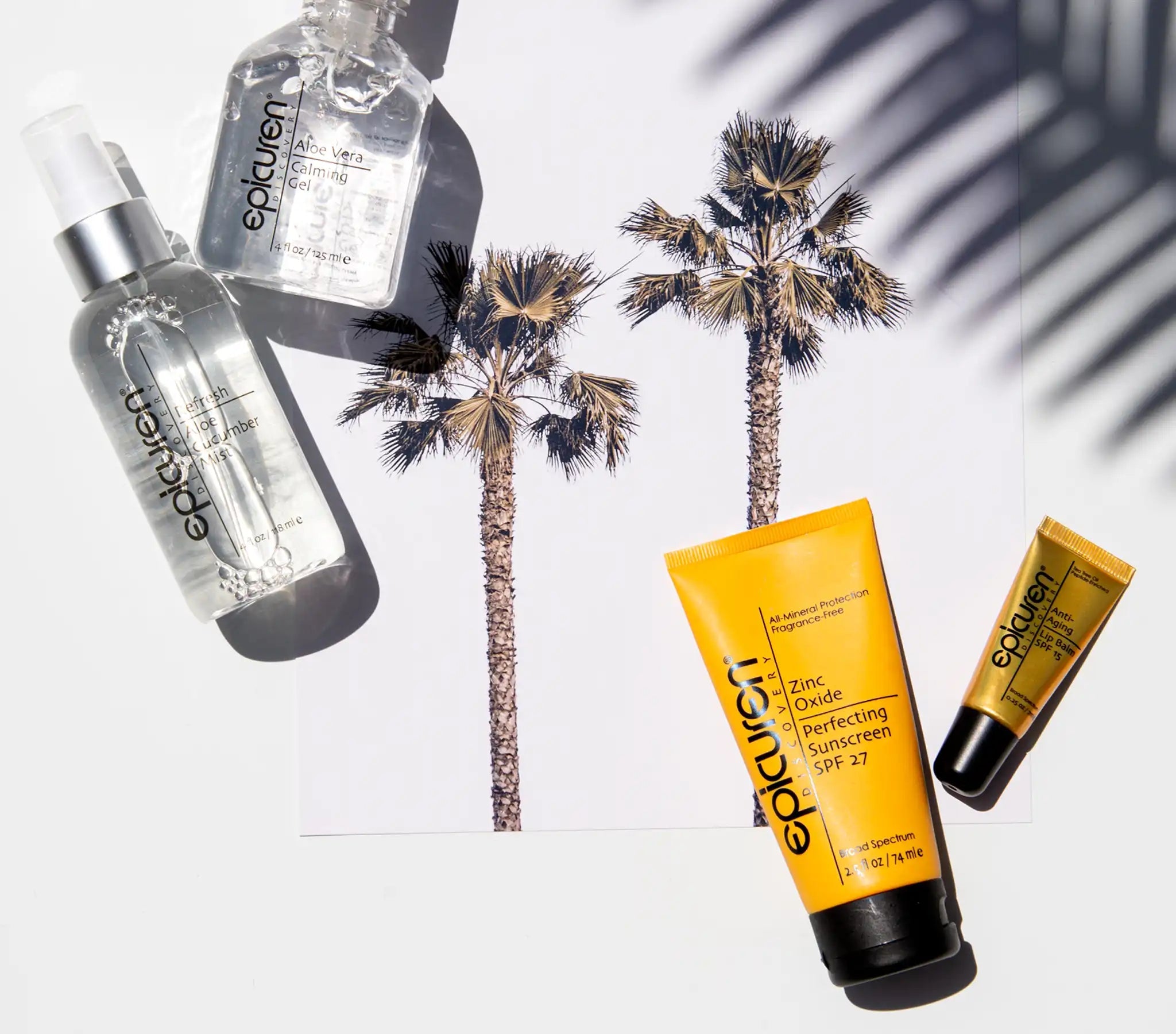 Epicuren skincare products including Epicuren Zinc Oxide Perfecting Sunscreen SPF 27 with palm trees in the background