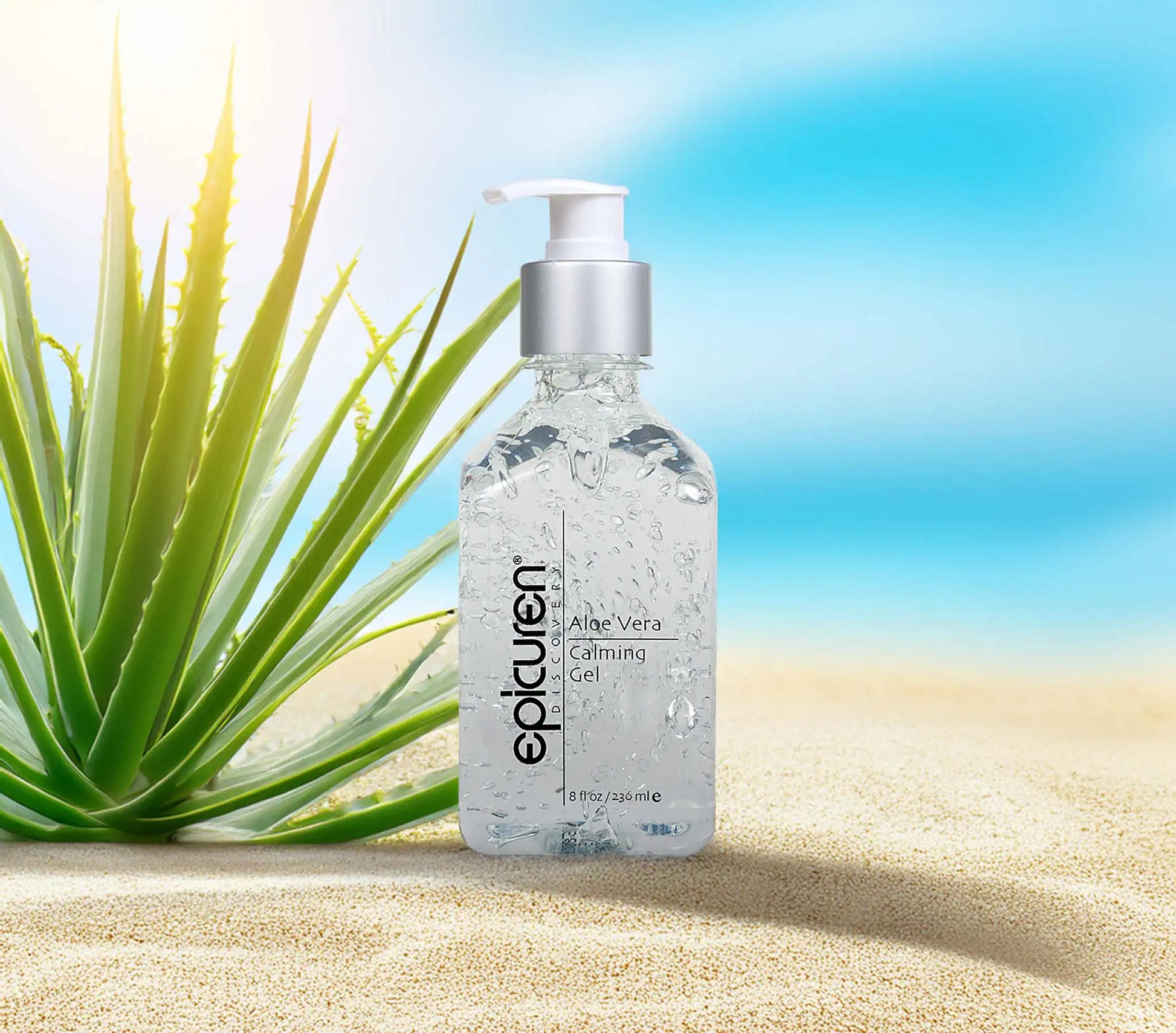 Bottle of epicuren Aloe Vera Calming Gel with an aloe plant on sand and blue sky background